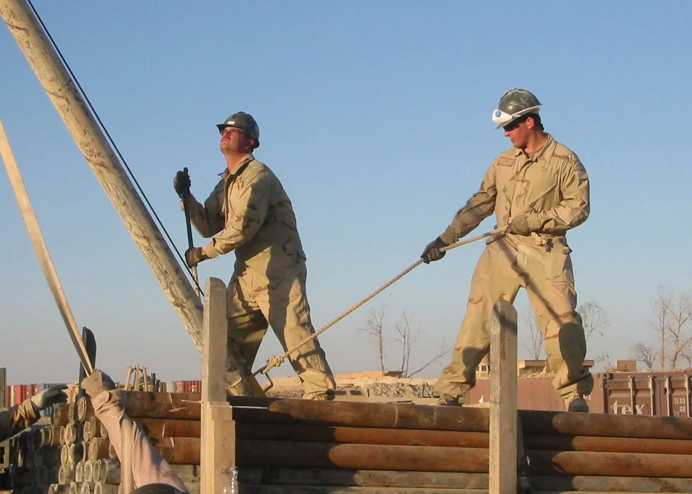 drill collar — US Navy 061008-N-4921S-002 Equipment Operator 1st Class, Bryan Anselmi (left) of Copperopolis, Calif., and Construction Electrician 2nd Class, Thomas Lamb of Seattle, Wash., moves a drill collar into position for attachment to